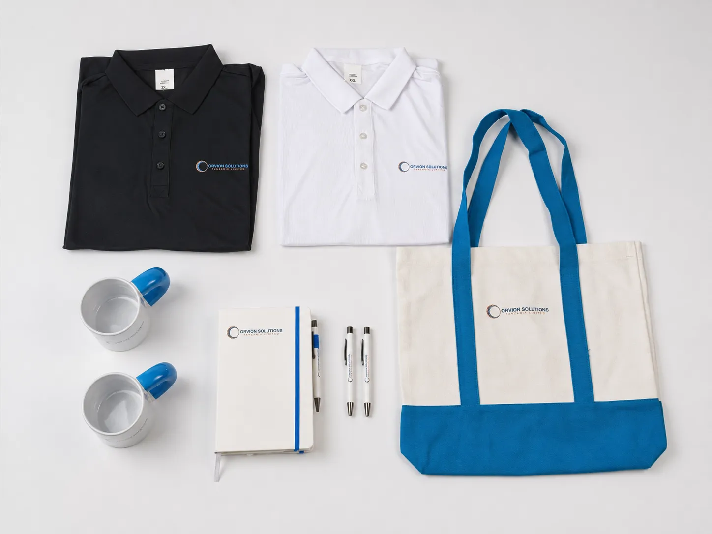 Custom corporate gift set with polo shirts, canvas bag, notebook, pens and mugs