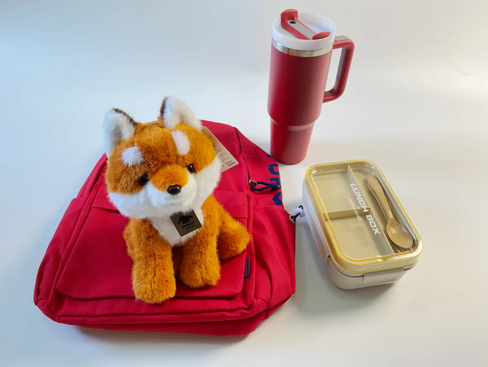 Rowley's custom branded merchandise collection with fox plush toy, backpack, wheat-straw lunch box and stainless steel tumbler
